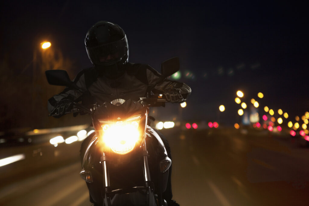 Young Man riding a motorcycle at night in Irvine